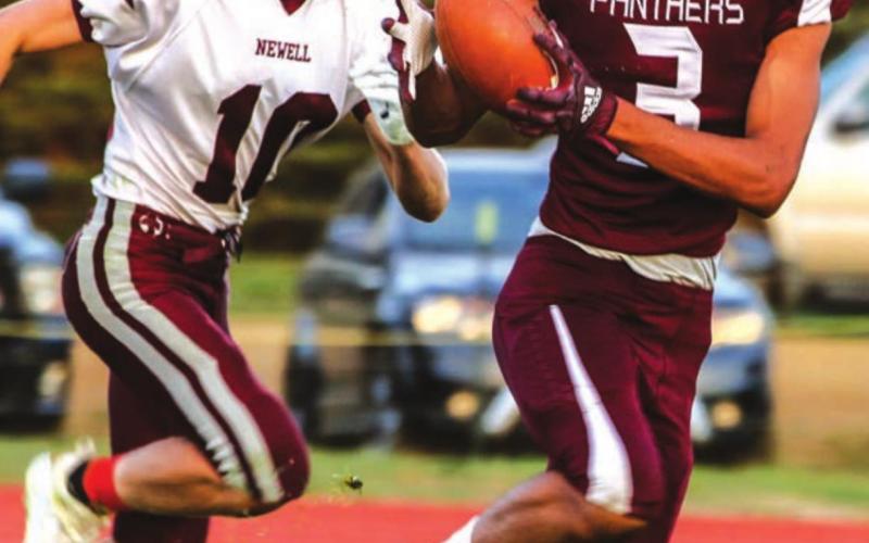 ABOVE: Chazz Gabe (3) hauls in a pass as he runs past Chase VanderBoom (10) during the TLHS homecoming game.