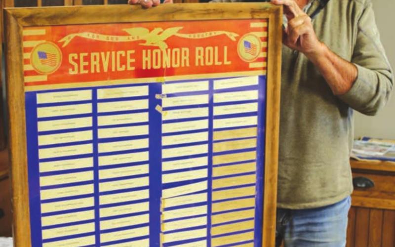 Isabel American Legion Post 120 Commander Jim Boldt shows a World War II service honor roll that was recently discovered in the former Isabel Community Hall.