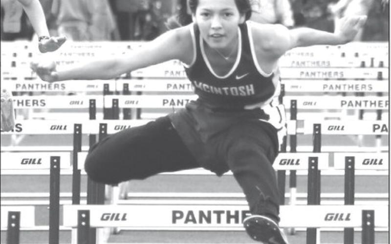 Eighth grader Aleah Hettich of McIntosh eyes the finish line while clearing a barrier in the 100 meter hurdles at the Timber Lake Track Invitational held last Thursday, May 2, at Doug Kraft Field. Hettich won the event and also finished second in the 300 meter hurdles. Photo by Jon Flatland
