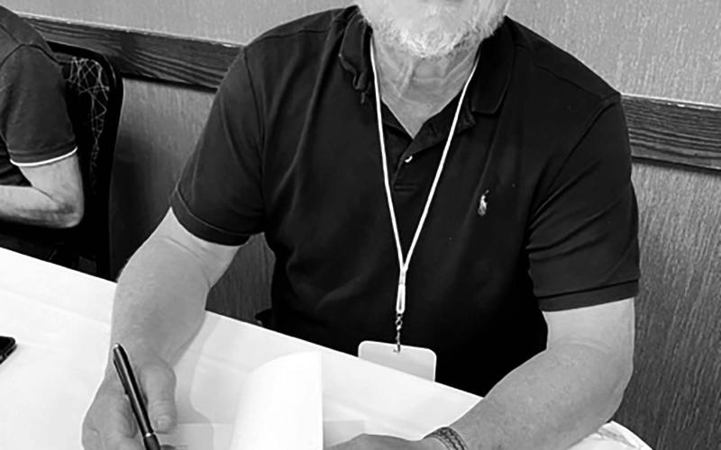 Author Chuck Raasch autographs copies of his book at the South Dakota Festival of Books in Deadwood in September. Photo by Karen Holzer