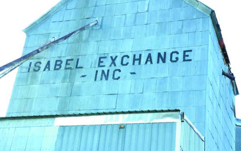 The two century-old 100-foot grain elevators located on the south side of Isabel will fall under a wrecking ball in the next few weeks. Neither grain crib has been used since 2010 and were condemned shortly thereafter. CHS, which now owns the property, said a 50-ton truck scale installed in 1985 will remain in place with plans calling for the construction of a new scale house.