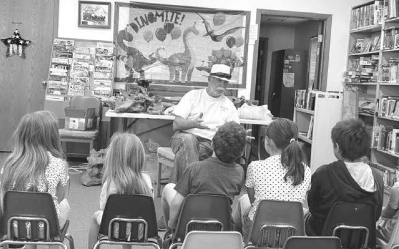 Greg Garon of Timber Lake talked about paleontology at the Dewey County Library’s Summer Reading Program on July 1. The theme of this year’s summer reading program is “Unearth a Story.” Programs continue on July 8, 15, 22 and 29. Attending last week were: Leon Shoots the Enemy, Rhett Aberle, Marie Bad Warrior, Eddie Vogel, Maren Maher, Rowan Maher, Remi Aberle, and Taylor Dupris. Photo by Ann Arnold