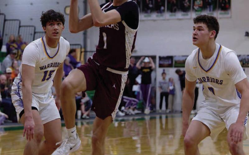Left, Timber Lake forward Jackson Bigger (1) splits a pair of Castlewood defenders Leonard Wernke (15) and Kamden Keszler (0) on a drive to the hoop during the Panthers matchup with the Warriors in the SoDak 16 last Tuesday. Topic Photo/Marie Du Preez