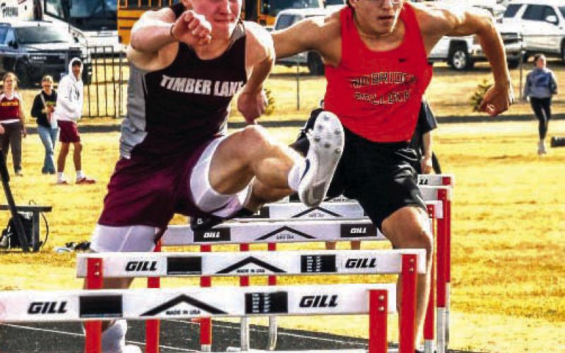 Gracen Hansen of Timber Lake nipped Simon Fried at the finish line to win the 300-meter hurdles at 41.14. With Fried running 41.22, both runners were faster than the meet record 42.49 run by Cody Cotton of Faulkton in 1998. Photo by Jay Davis/Mobridge Tribune