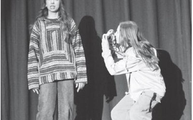 While Izzy (Zoey De La Rosa) shares various interesting facts about birds, Dove (Laynee Bakeberg) captures her emotions and expressions on camera. The two girls received superior acting awards at the regional one-act play competition.