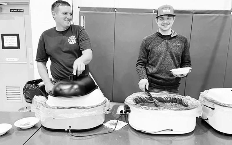 AT RIGHT: Brent Spafford and Riley Lindskov served up chili and chicken noodle soup at the Isabel Firemen’s Supper.