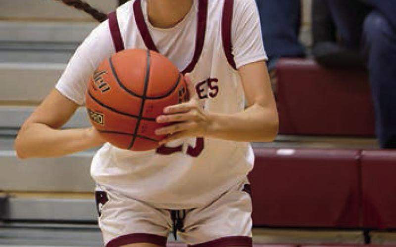 Above: Jaylee Schoelerman of Timber Lake keeps her eyes on the basket as she drives past a New Underwood defender for a lay-up attempt. Schoelerman led the Lady Panthers with 12 points and 8 rebounds in an overtime loss. Left: Autym Red Bear sets herself for a 3-point attempt in the Panthers’ overtime loss to visiting New Underwood. Topic Photos/Marie DuPreez