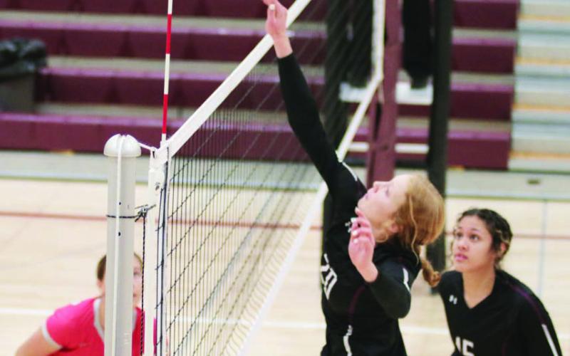 Kendyl Locken, a 5-10 junior, tips a shot over the net during Timber Lake Lady Panther volleyball action against Potter County on Monday, Oct. 17.