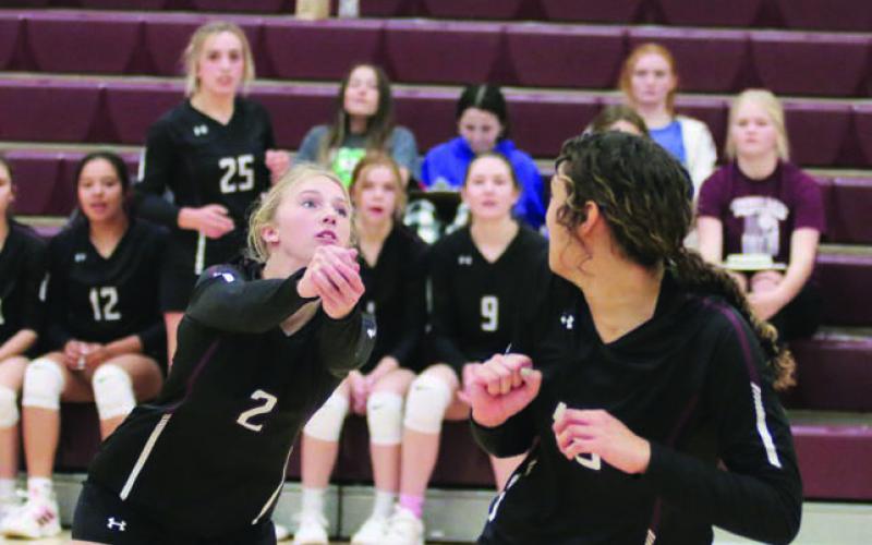 Photo by Jon Flatland Averie Marshall (2) returns a shot against Potter County while teammates look on from the bench and teammate Jasmine Nash (right) ducks out of her way. Photo by Jon Flatland
