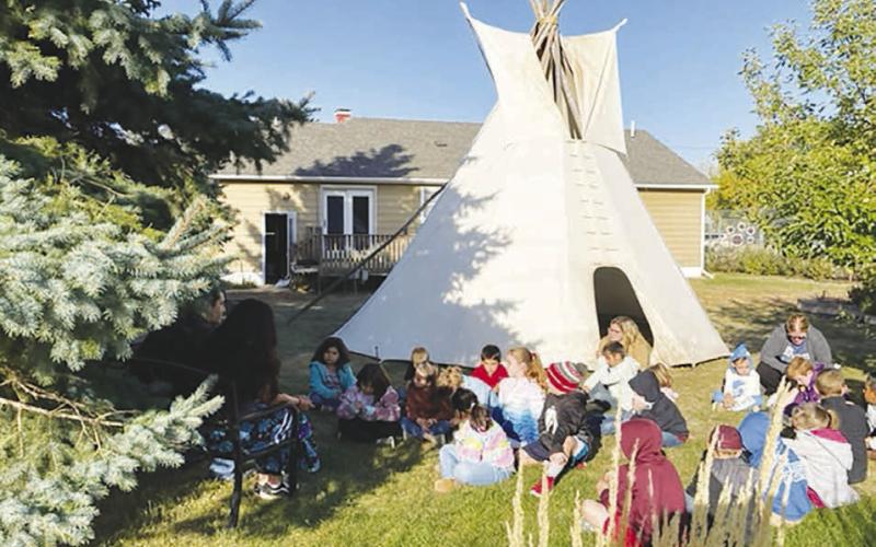Dave and Michelle West set up a tipi in the school-community garden, where they shared Lakota stories and legends with elementary students.