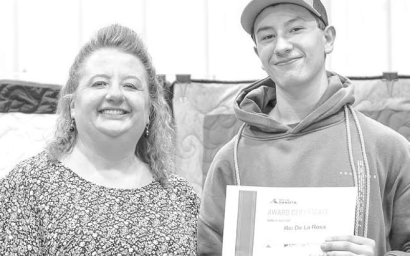 Patty Peacock presented Rio De La Rosa with a Build Dakota Scholarship that will pay for all of his tuition/fees/tools as he attends Lake Area Technical College this fall.