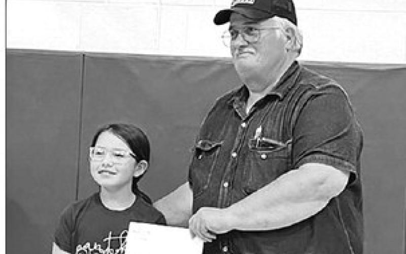 Lance Willison (RIGHT) won the drawing for the $250 grand prize. Timber Lake fourth grader Leah Eigelaar drew names for the prizes.