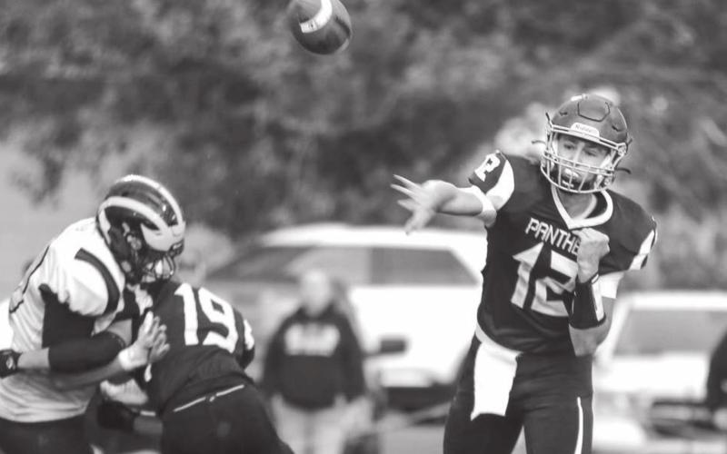 Senior quarterback Kedrick Martin (12) tosses a dart to an open teammate as running back Jayce Lawrence (19) picks up the blitz during the TLHS Panthers’ loss to the HSA Wolverines. Photo by Jon Flatland