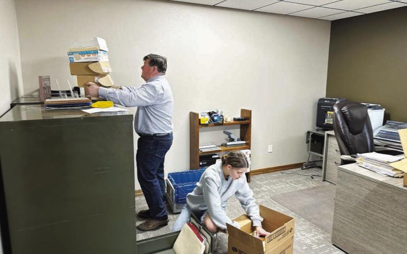 Ryan Maher, assisted by Meredith Maciejewski, moved his Western Dakota Insurance office to the new building.