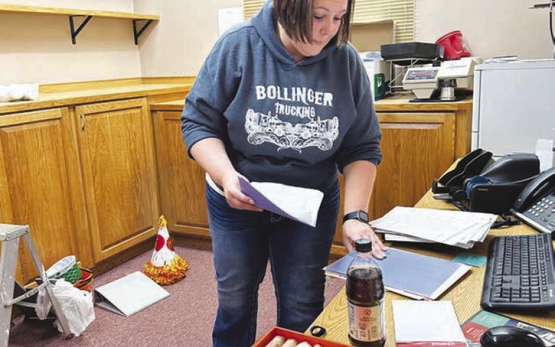 Jennifer Bollinger packs up the contents of a work room.