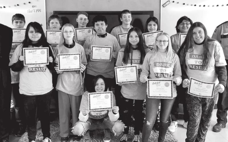 McIntosh DARE graduation. FRONT (L-R): Guest speaker Shane Penfield, Mileigh Eagle, Mia Hanson, Olivia Geigle, Jessmyn Hertel, Kaitlyn Lynch, Abundance Bjornstad; BACK: Dominick Klein, Adam Jaragoske, Wyatt Larson, Carmelo Little Eagle, Curtis Conner, Ozziah Ulmer, Corey Flying Bye, Corson Co. Sheriff Alan Dale.