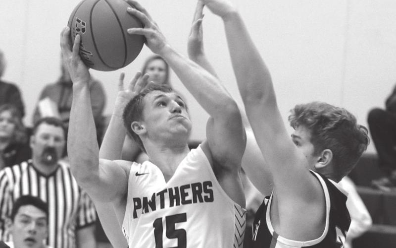 Timber Lake senior Hank Kraft powers to the hoop during home varsity basketball play versus North Central Photo by Jon Flatland