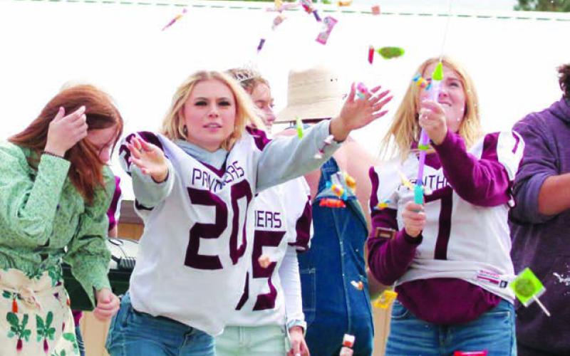 Seniors shoot candy into the crowd at the Homecoming parade.