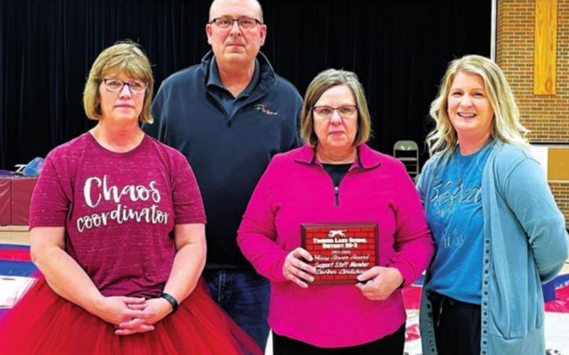 Longtime paraprofessional LeAnn Lindskov (WITH PLAQUE) received a Missy Stover Support Staff of the Year Award, presented by (L-R) MS/ HS Principal Julie Marshall, Supt. Dan Martin, and Elementary Principal Danae Paxton.