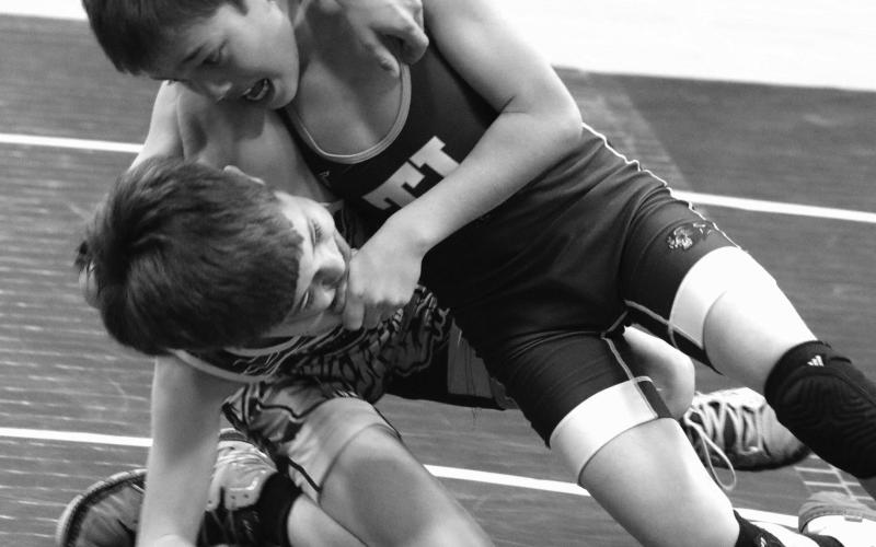 Ryder Veit (right) of the Timber Lake Youth Wrestling Club, holds Dupree’s Kemper Longbrake in a headlock while driving him to the mat during their Midgets 67 Division match at the first-ever Panther Invite Triangular featuring wrestlers from Timber Lake, Dupree and Mobridge. Veit finished third at the SDWCA District 3 regional championship last weekend and will compete at the state meet March 1517. Longbrake placed fourth in regionals, just missing the cut for state qualification. Photo by Jon Flatland