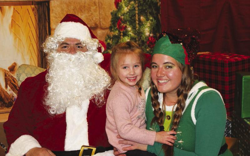 Dupree Parade of Lights event organizer, Janna Hunt, and her niece, Kayzli, enjoy a precious moment with Santa.