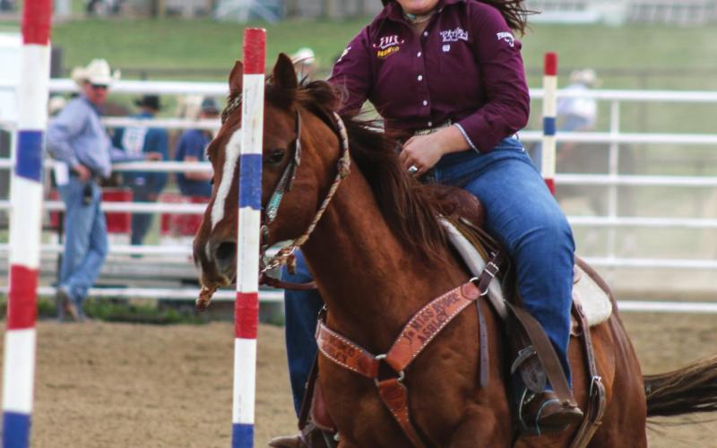 Tobi Hintz of Trail City weaves in the pole bending. Photos by Jon Flatland