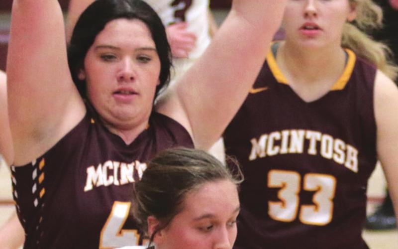 Timber Lake senior Tessa Goldade works a post move while defended by McIntosh senior Nadaley Webb (44) and junior Chloe Sandland (33).