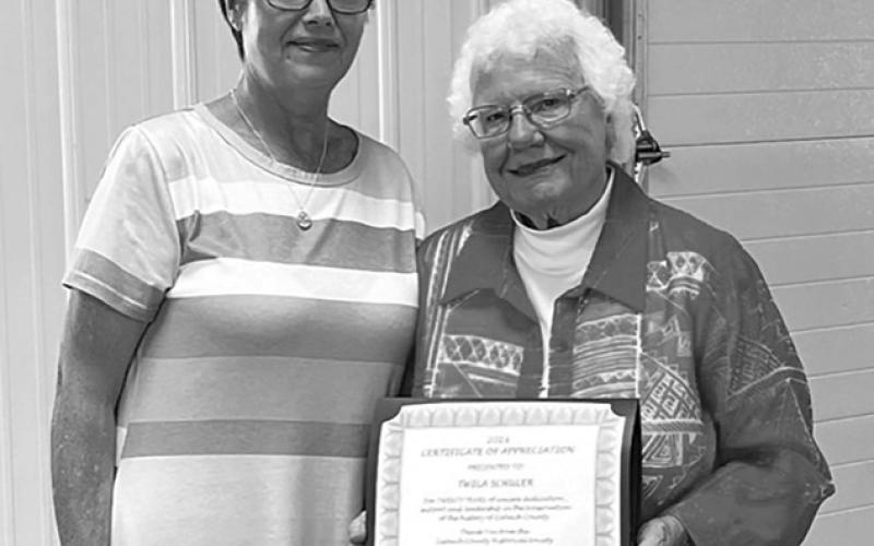 Sunday July 9, 2023 was celebrated as Twila Schuler Day in Dupree and Ziebach County. ABOVE, Darla Vrooman (LEFT) presents Twila with a plaque honoring her for 20 years of service and leadership in preserving Ziebach County history.