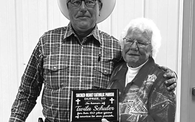 Dale McLellan presents Twila with a plaque in recognition of her 60-plus years of service to Sacred Heart Catholic Parish. Photos by Evelyn Anderson