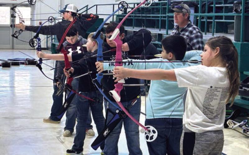 Aidan Lindskov sights in an air rifle prior to target practice at the Isabel Community Center on Sunday afternoon. Photos by Jon Flatland