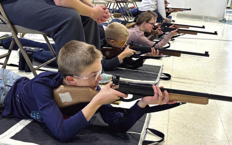 Members of the Wildcat Dead Eyes Shooting Sports Club take target practice with spotters and coaches to assist them at the Isabel Community Center. More than two dozen area youth are participating in the shooting program, which is now in its 10th year.
