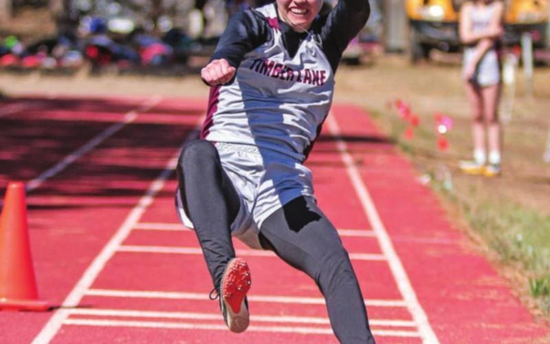 Timber Lake’s Natalie Biegler braces for a landing in the long jump.