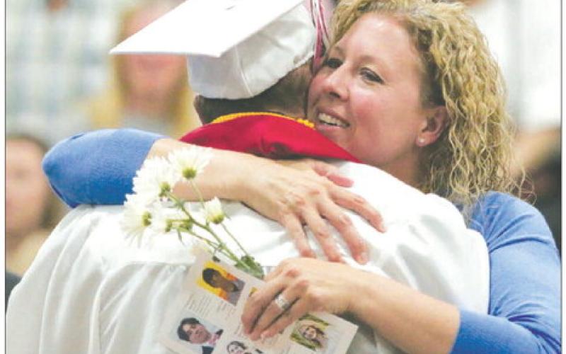 Tennile Lindskov smiles as she hugs her son, A.J., after he presented her with flowers during the Timber Lake High School Class of 2023 graduation program on Sunday, May 7. A.J. was later presented his diploma by his father, Bryce, who serves as vicepresident of the Timber Lake School Board. Photo by Jon Flatland