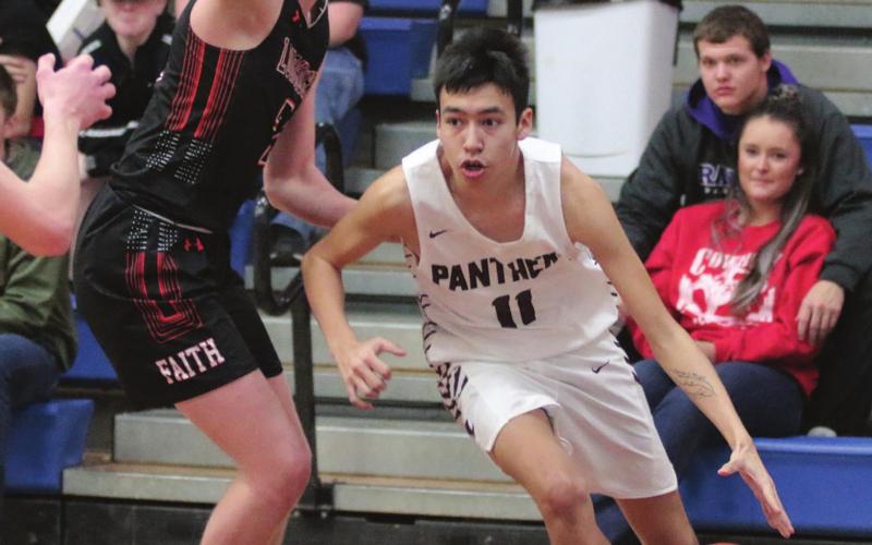Timber Lake guard Tristan Dupris dribbles the ball past Faith’s Jackson Schauer during the Little Moreau Conference tournament finals. Photos by Jon Flatland