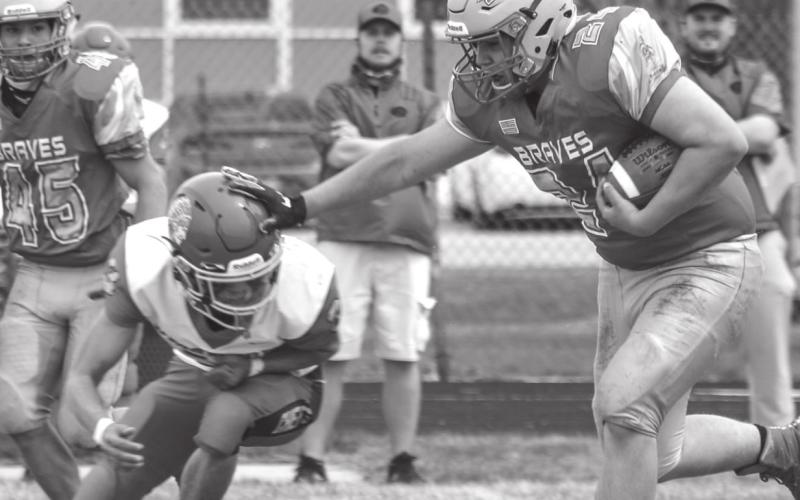 Cheyenne-Eagle Butte senior running back Antonio Lasley stiff arms an Omaha Nation defender during All Nations Football League action in Eagle Butte on Friday, April 30. The 1-3 Braves will travel to McLaughlin this Friday, May 7, to take on the 0-2 Mustangs. Photo by Jon Flatland