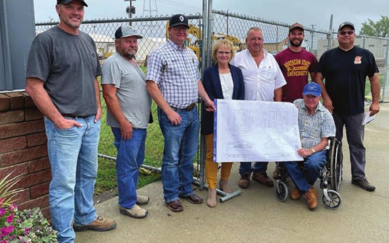 LEFT: Western Dakota Bank President John Templer (SEATED) with some of the local contractors who will build the new 60 x 65 ft. building for Western Dakota Bank. L-R are Greg Handeland of Octa Flex, Jim Miller of Miller Construction, Rusty Gebhardt and Karma Nash of Western Dakota Bank, Marty and Scott Biegler of Three Seasons Tent Rental and Construction, and Richard Gross of Octa Flex.
