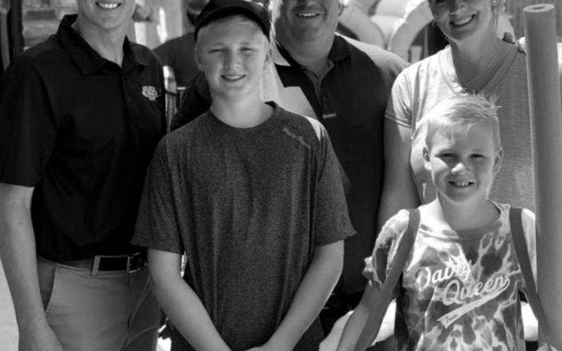 Dairy Queen owner Lonnie Heier (BACK, MIDDLE) and his family with Nathan Sanderson, executive director of the S.D. Retailers Assn. last summer.