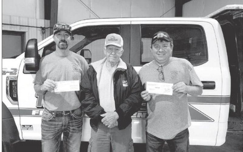 Moreau-Grand board chairman Larry Hieb (MIDDLE) presents a check for $1000 to Jeremy Bollinger (LEFT) and Grady Kraft (RIGHT) of the Timber Lake Volunteer Fire Department.