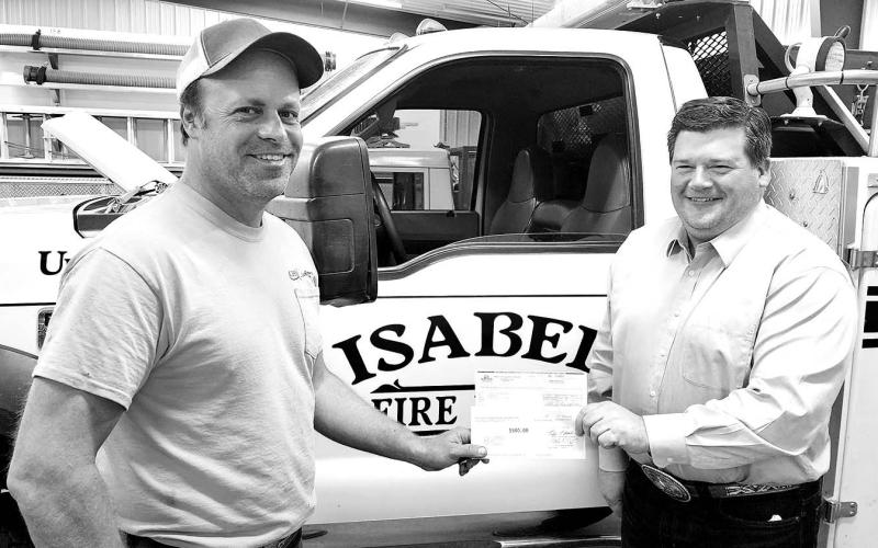 ABOVE: Moreau-Grand board member Ryan Maher (RIGHT) presents a check for $1000 to Tony Russell of the Isabel Volunteer Fire Department.