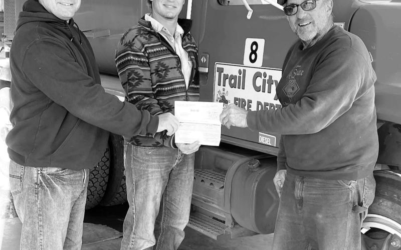 RIGHT: Moreau-Grand Electric board member Kelly Landis (RIGHT) presents a check for $1000 to Rio Jones (LEFT) and Brady Bickel (MIDDLE) of the Trail City Volunteer Fire Department. Photos courtesy of Moreau-Grand Electric