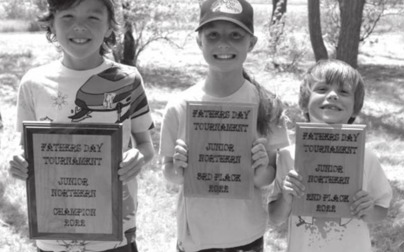 Plaque winners in the fishing tournament at Isabel Lake on Saturday were (l-r) Hayden Bader, first place; Hailey Bader, second place; and Michael Bader, third place.