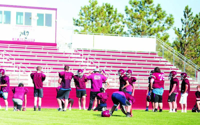 Head Coach Ryan Gimbel leads the Timber Lake Panthers through an offensive drill during practice at Doug Kraft Field on Monday. The Panthers will open their 2022 football season on Friday, Aug. 19, facing Lemmon-McIntosh in Lemmon. Photo by Jon Flatland