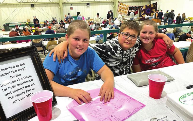 Titcket takers and honorary/future firemen (L-R) Cody Russell, Gabe Bridges and Trent Russell greeted attendees of the Isabel Volunteer Fire Department’s fundraiser Oct. 23. Photo by Kathy Nelson