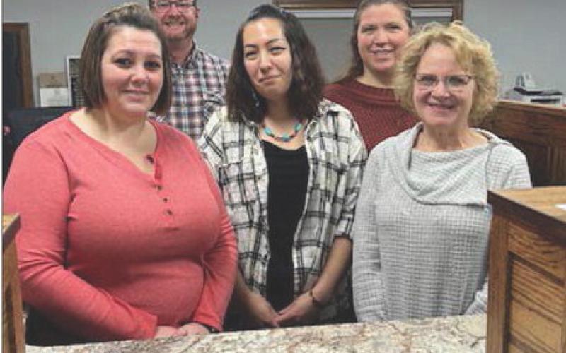 Staff at Western Dakota Bank (FRONT) L-R: Jennifer Bollinger (cashier), Amy Taylor (teller), Karma Nash (senior vice-president); BACK: Rusty Gebhardt (senior vice-president) and Kayla Kennedy (teller). President John Templer is not pictured but plans to attend the grand reopening. Photo by Jon Flatland