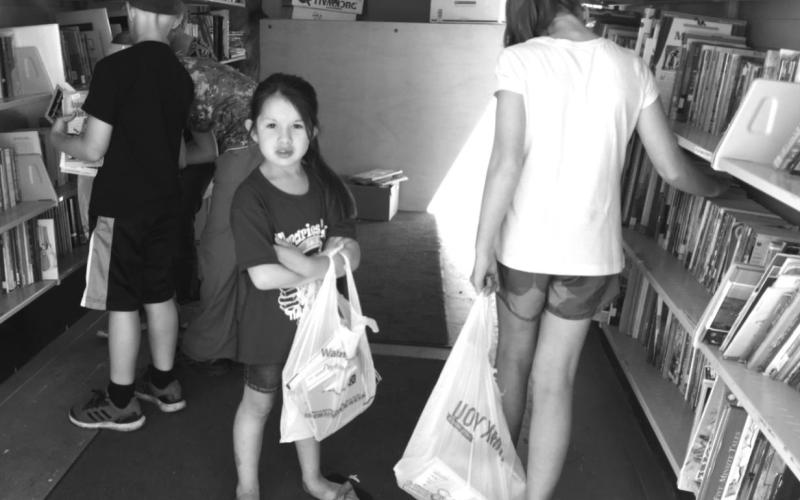 When the St. Joseph’s Bookmobile stopped at Timber Lake in 2019, Leah Eigelaar (CENTER) found some books to take home. Last year the Bookmobile did not tour due to the COVID-19 pandemic.
