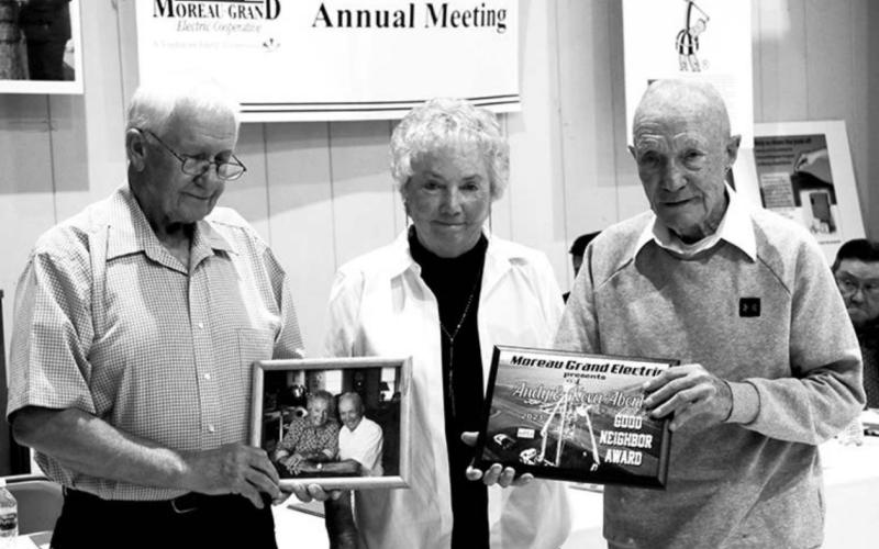 Moreau-Grand Electric board president Larry Hieb (EFT) presents the Good Neighbor Award to Keva and Andy Aberle of Timber Lake at the M-G annual meeting.