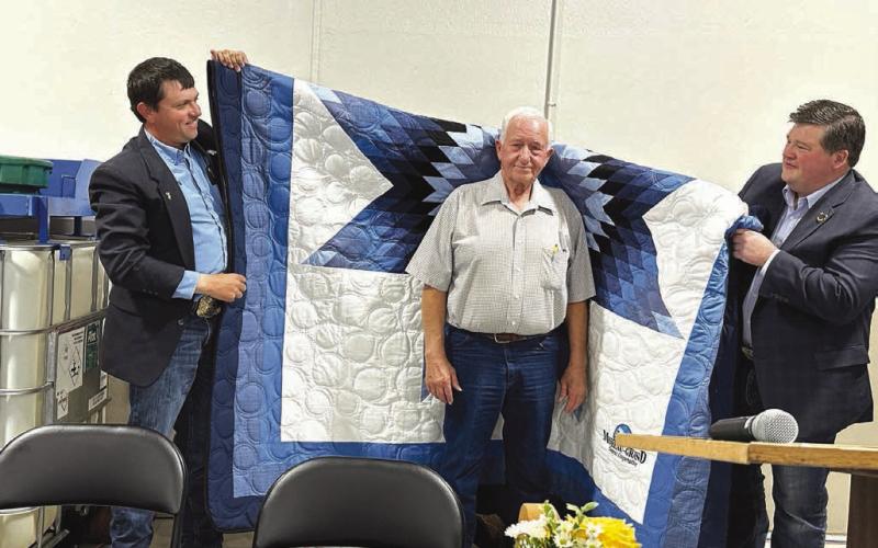 ABOVE: Larry Hieb was honored with a star quilt in recognition of his 55 years of service to Moreau-Grand as an employee and director. Making the presentation were (left)Kerry McLellan (vice-president of the board of directors) and Ryan Maher (president of the board).