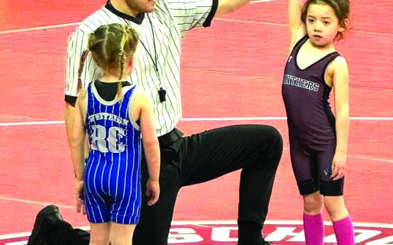 Ramzi Veit of the Timber Lake Youth Wrestling Club has her armed raised in victory during one of her matches at the SDWCA State Tournament in Rapid City last weekend. Veit finished third overall in the Girls Tots 40 division.