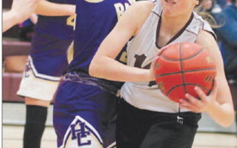 Timber Lake’s Jaylee Schoelerman takes a body check from a Harding County defender while driving the lane during the 2022 LMC Middle School Girls Basketball Tournament on Saturday, Dec. 3. Timber Lake finished third and Harding County was runner-up to Lemmon. Photo by Jon Flatland