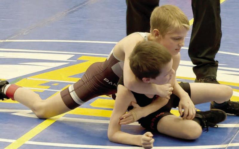 Barrett Hermes (top) works to get a hold on an opponent at the SDWCA Region 2 Youth Wrestling Tournament in Aberdeen on Sunday, March 15. Eighteen members of the Timber Lake Youth Wrestling Club advanced to compete in the State Tournament March 28-30 in Rapid City. Photo by Mikki Veit